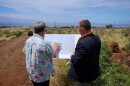 Gov. Josh Green and state Department of Human Services Deputy Director Joe Campos look over a site plan for Ka Laʻi Ola on Maui. (March 25, 2024)