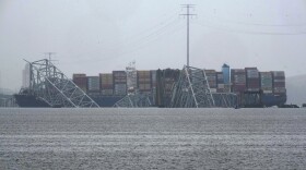 A container ship rests against the wreckage of the Francis Scott Key Bridge on Thursday, March 28, 2024, in Baltimore, Md. After days of searching through murky water for the workers missing after the bridge collapsed, officials are turning their attention Thursday to what promises to be a massive salvage operation. (AP Photo/Matt Rourke)