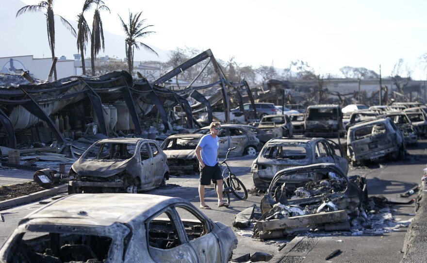 FILE - A man walks through wildfire wreckage Aug. 11, 2023, in Lāhainā, Hawaiʻi. Maui authorities said Thursday, Sept. 14, that they are planning to start letting residents and business owners make escorted visits to their properties in the restricted Lahaina Wildfire Disaster area later this month. (AP Photo/Rick Bowmer, File)