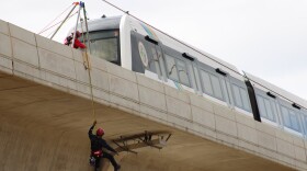 Honolulu Fire Department Rescue 1 team members repel down from the Honolulu Rail Transit line on Saturday, Oct. 22, 2022.