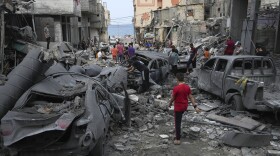 Palestinians inspect the rubble of the West mosque destroyed after it was hit by an Israeli airstrike at Shati refugee camp in Gaza City, early Monday, Oct. 9, 2023. Israel's military battled to drive Hamas fighters out of southern towns and seal its borders Monday, as it pounded the Gaza Strip from the (AP Photo/Adel Hana)