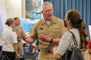 FILE - Joint Task Force-Red Hill Commander U.S. Navy Vice Adm. John Wade speaks with a resident during an open house hosted by the Hawaiʻi Department of Health at Moanalua High School on June 5, 2023.