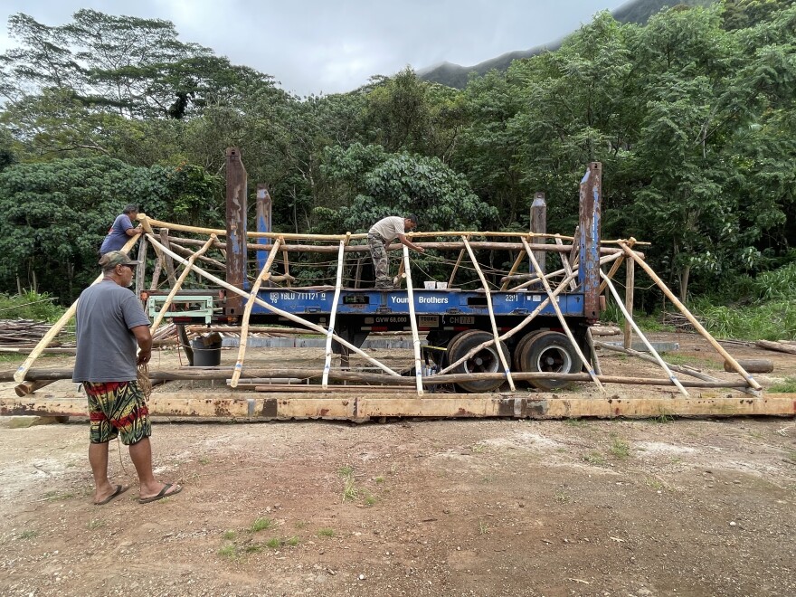 Crews are built a mock-up hale for the Festival of Pacific Arts and Culture.