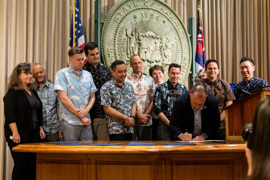 Local officials watch Gov. Josh Green sign a handful of housing reform bills that passed through the state Legislature. (May 28, 2024)