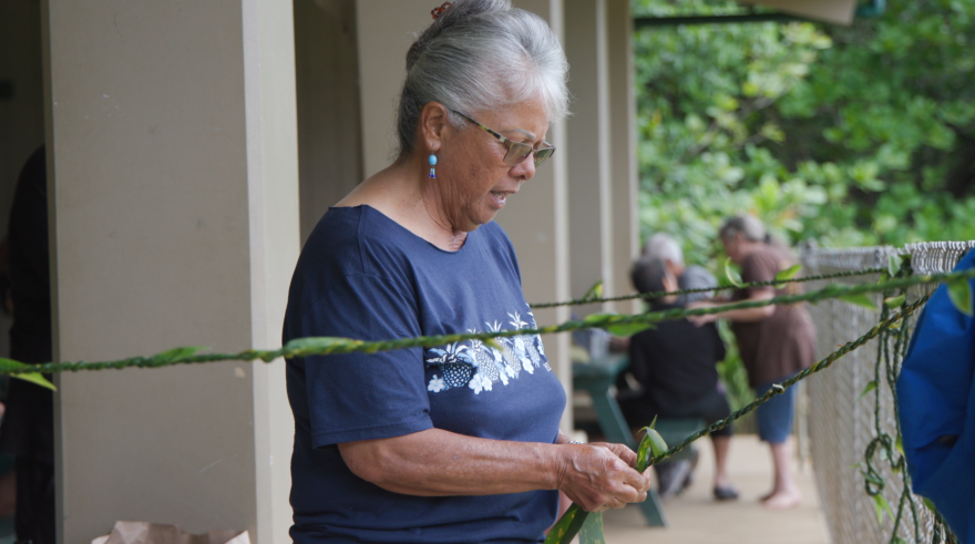 Kohala kupuna Sarah Pule-Fujii joins in the lei-making fun at Kēōkea Beach Park in Kapaʻau over the weekend.